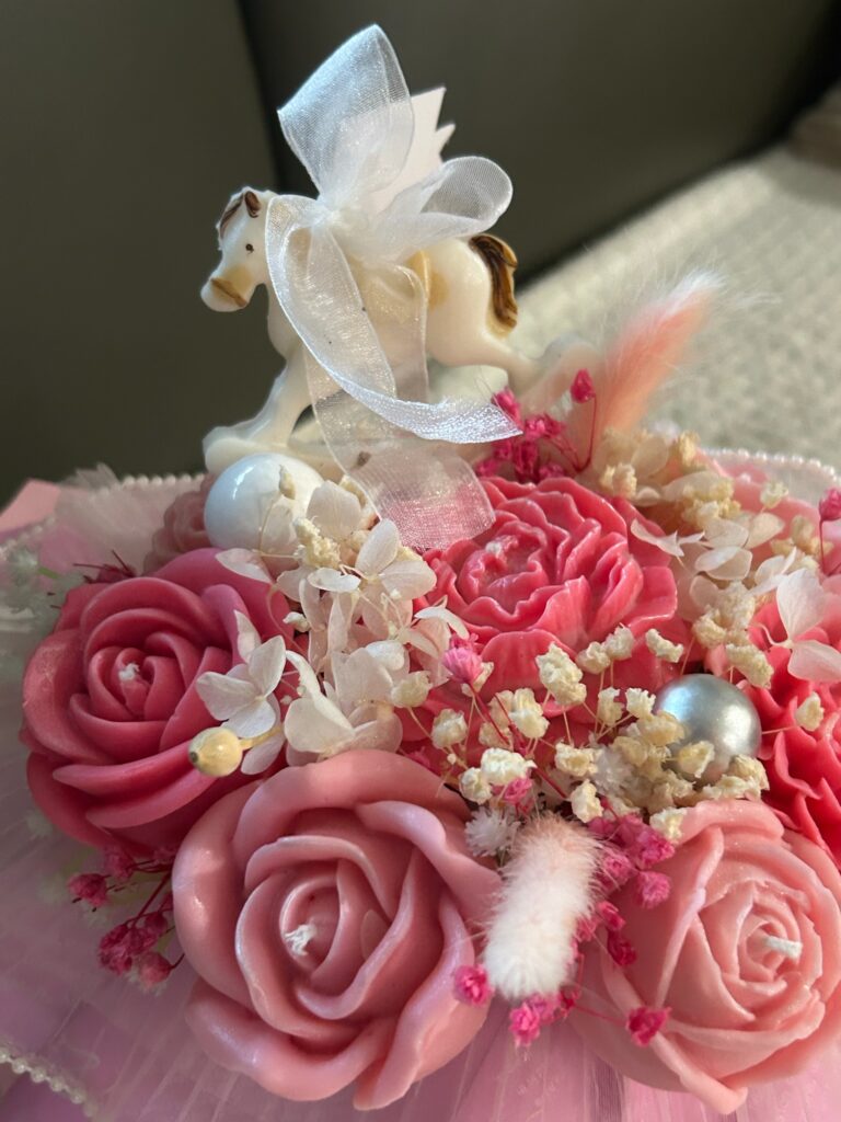 A Gift from the Heart Elevate your gifting game with a bouquet that captures the essence of love and the beauty of nature. Our Heart-Shaped Floral Bouquet Candle is a stunning fusion of sculpture and scent. Intricately molded with a cluster of delicate blossoms into a perfect heart silhouette, this 9-inch tall masterpiece serves as a breathtaking centerpiece for any romantic occasion. Signature Scent Profile Experience a layered floral journey designed to soothe and uplift: Top Notes: Sweet Tangerine & Tea Heart Notes: British Rose, Jasmine, and Tuberose Base Notes: Soothing Lavender Product Highlights Height: 9 Inches Wax: 100% Hand-poured soy wax for a clean, non-toxic, and eco-friendly burn. Burn Time: Up to 36 hours of room-filling fragrance. Artisanal Craftsmanship: Every petal is uniquely detailed, ensuring your heart-shaped bouquet is a one-of-a-kind work of art. Care & Safety Instructions To keep your Mausam Art creation looking its best: The Perfect Base: Due to its unique shape, this candle is designed to drip artistically as it melts. Always place it on a heat-resistant, rimmed tray (glass or wood) to protect your surfaces. Wick Maintenance: Trim the wick to 1/4 inch before every light. This prevents soot and ensures an even, beautiful glow. The Heart-Shaped Floral Bouquet Candle